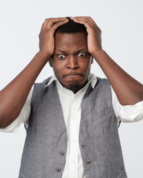 A stressed business owner with his head in his hands